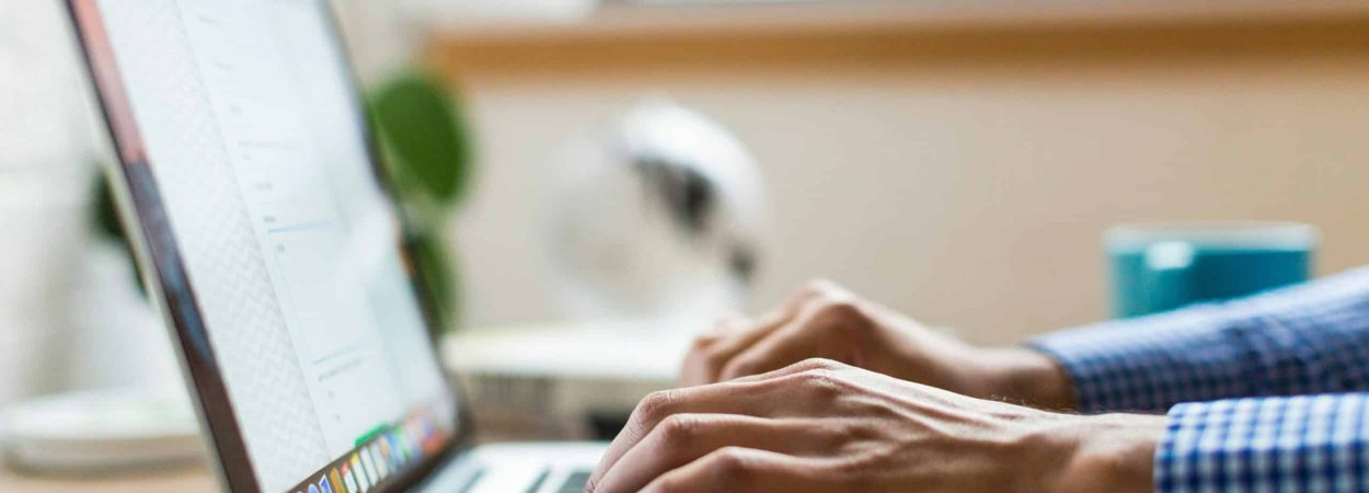 person typing on silver Macbook